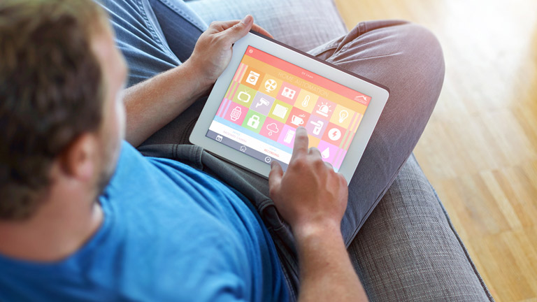 man controlling home security from a tablet