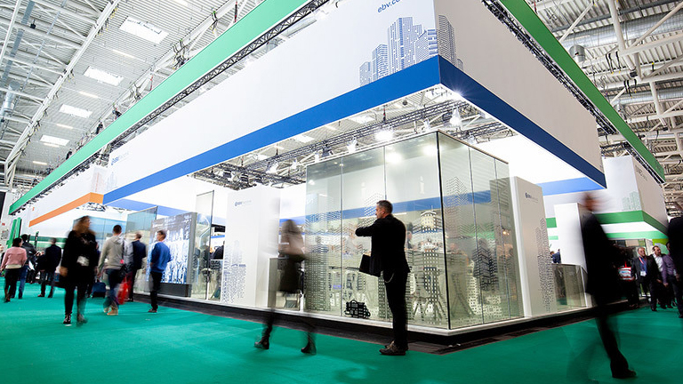 people walking by trade show booth