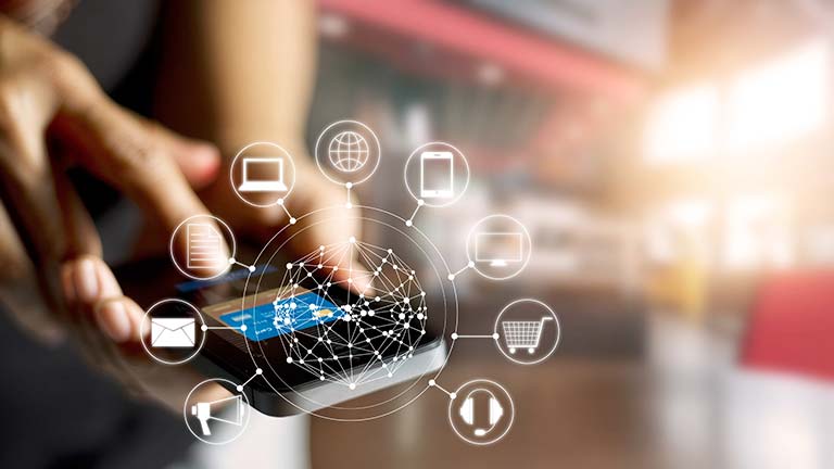 hands holding iPhone with overlaid IoT icons