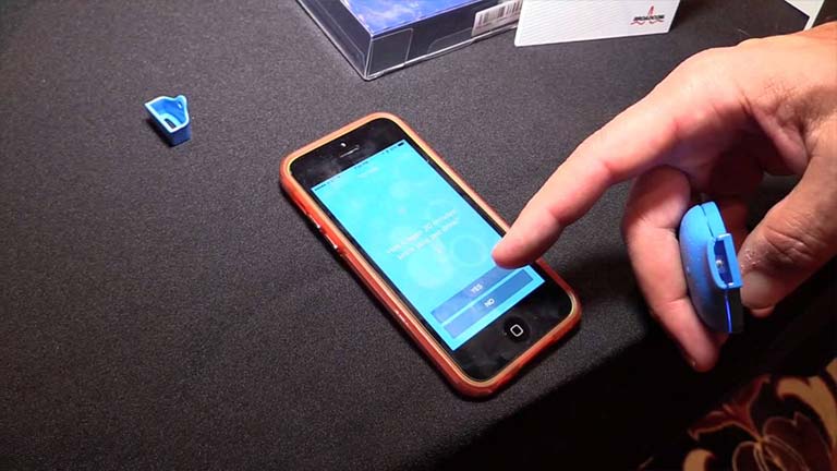 hand holding the Breeze breathalyzer and with results on iphone