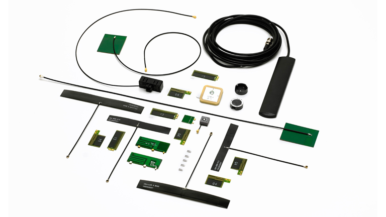A photo of various antennas laid out on a white background