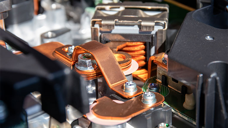 A close-up of an onboard charger in an electric vehicle