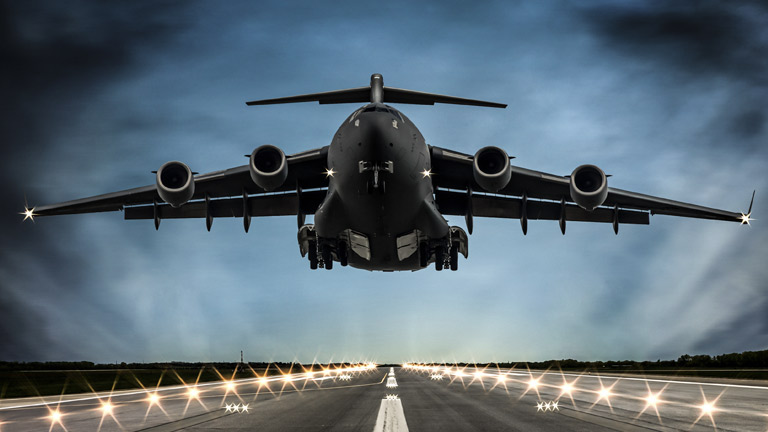 Airplane making a landing on the runway at dusk