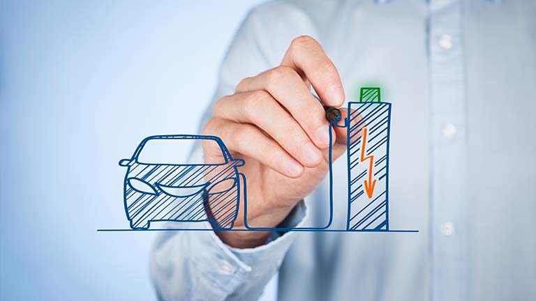 man drawing schetch of an electric car attached to a battery