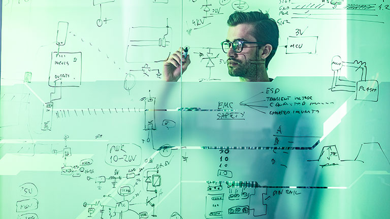 man drawing on glass wall