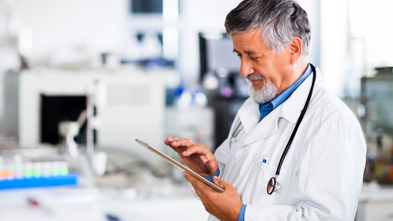 doctor using tablet computer