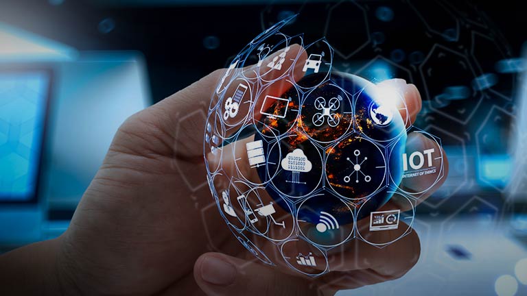 person holding superimposed globe with IoT symbols