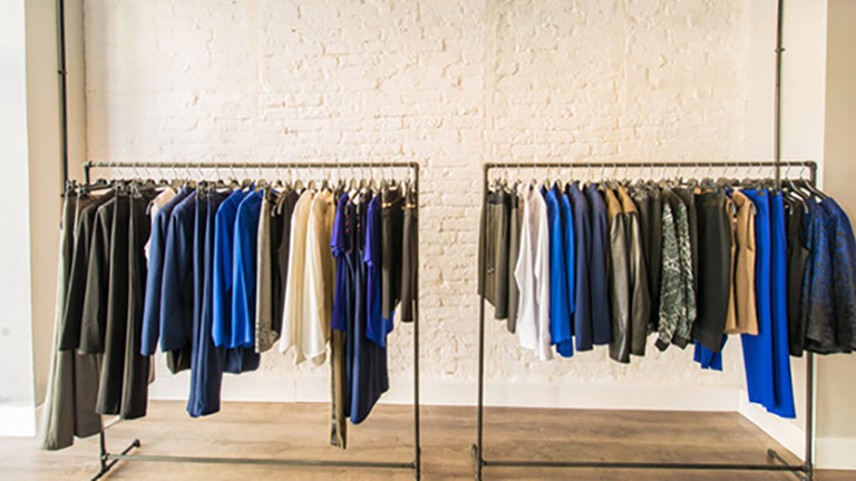 Clothes hanging on racks in a store
