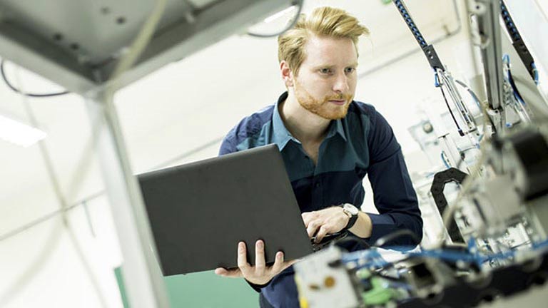 Young man holding laptop