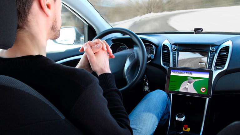 Man sitting in his car with self drive mode engaged