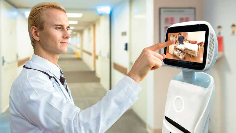 Doctor checking on a patient from a remote patient monitoring device