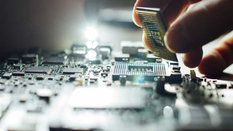 Person placing a component on a board