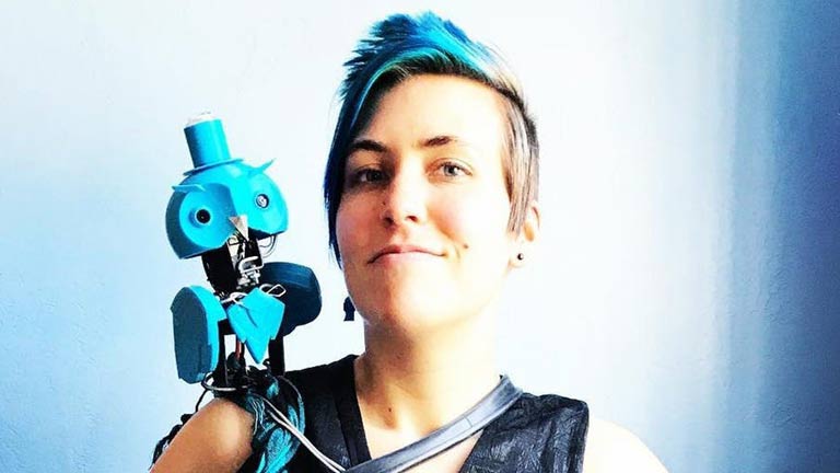 photo of young woman with robotic owl on shoulder