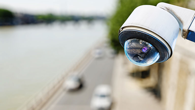 Security camera monitoring a lakeside street